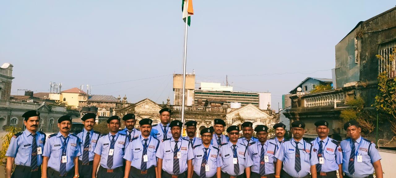 Combat security personnel assembled beneath the Indian flag